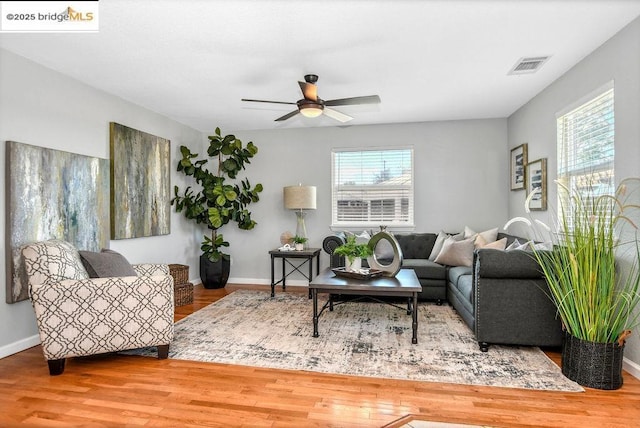 living room with ceiling fan, a wealth of natural light, and hardwood / wood-style flooring