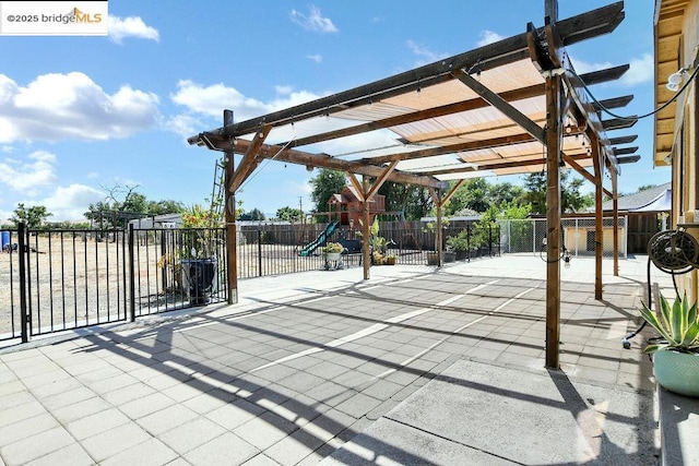 view of patio with a pergola and a playground