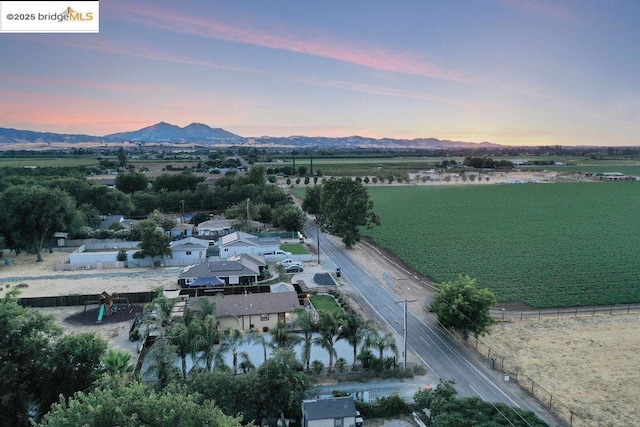 aerial view at dusk with a water and mountain view