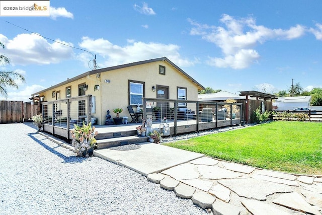 view of front facade featuring a deck and a front yard