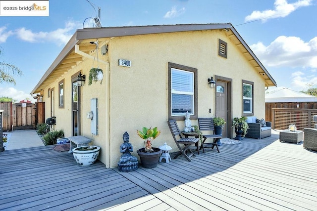 rear view of house with a wooden deck