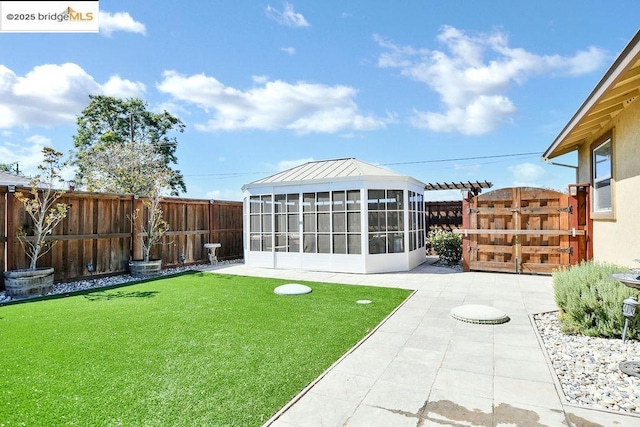 view of yard with a patio area and a sunroom