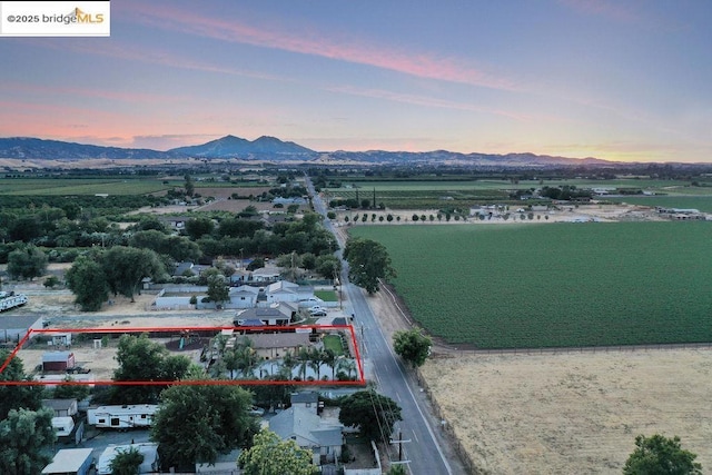 aerial view at dusk with a water and mountain view