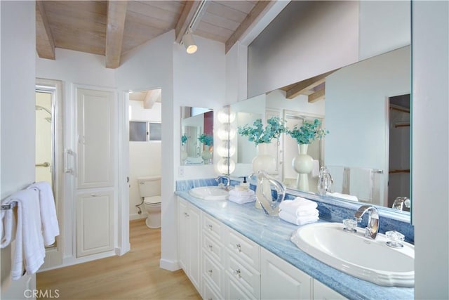 bathroom with vanity, toilet, lofted ceiling with beams, hardwood / wood-style flooring, and wooden ceiling