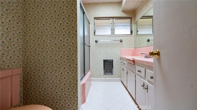 bathroom featuring tile patterned flooring, walk in shower, and vanity