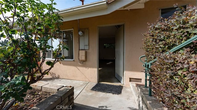 view of exterior entry featuring a patio area