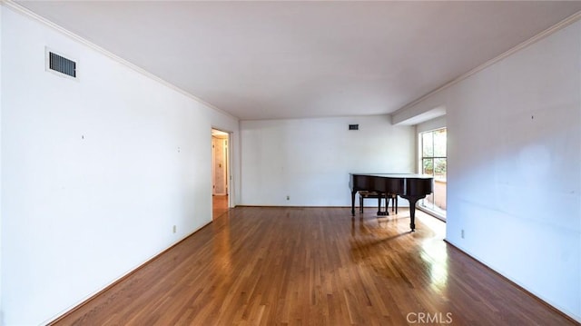 unfurnished room with crown molding and dark hardwood / wood-style floors