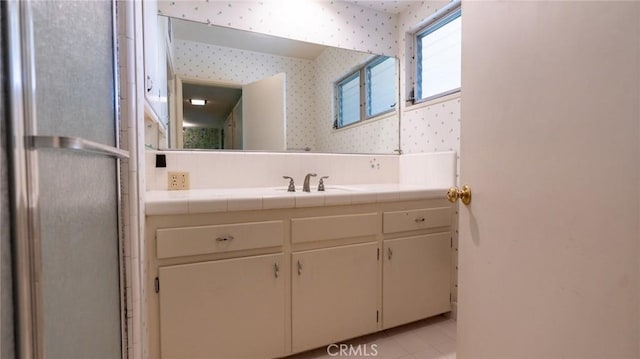 bathroom with tile patterned floors and vanity