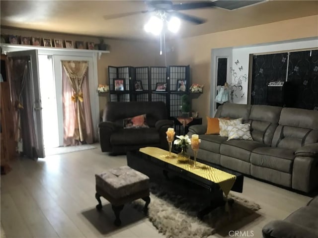 living room with ceiling fan and light wood-type flooring