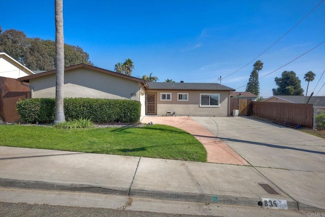 single story home with a front lawn