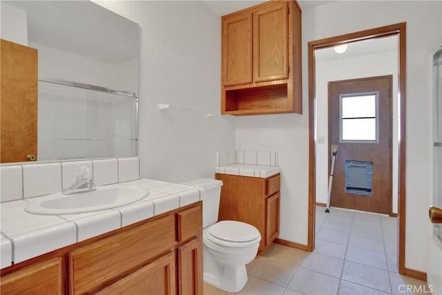 bathroom featuring toilet, tile patterned flooring, and vanity