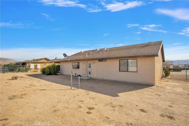 back of property featuring a mountain view