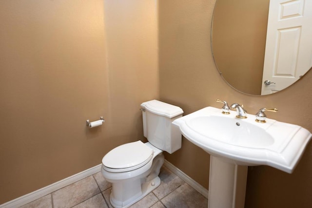 bathroom with toilet and tile patterned floors