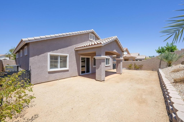 back of property with a patio