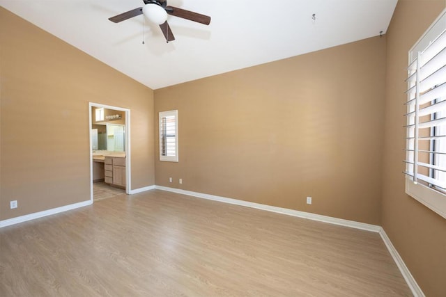 spare room featuring vaulted ceiling, ceiling fan, and light hardwood / wood-style flooring