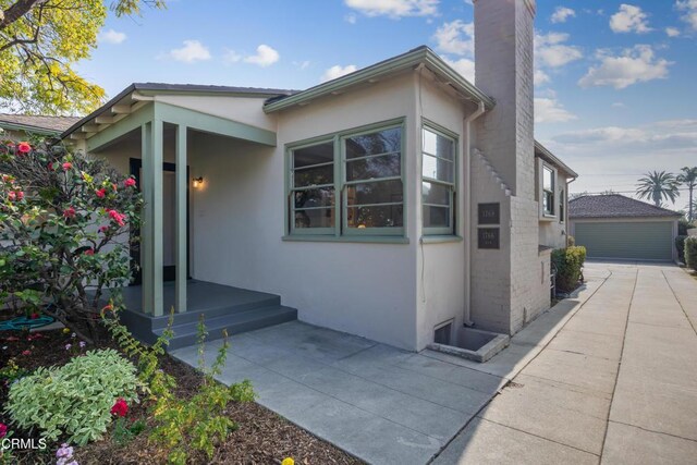 view of side of property with a patio area