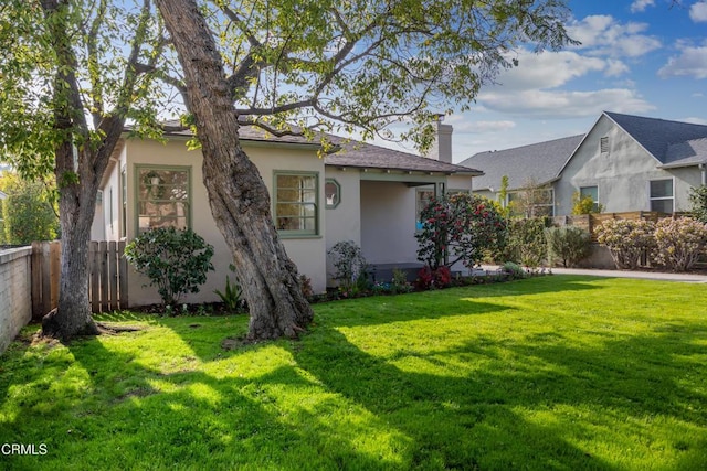 view of side of home featuring a lawn