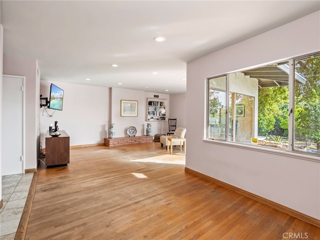 exercise area with light hardwood / wood-style flooring