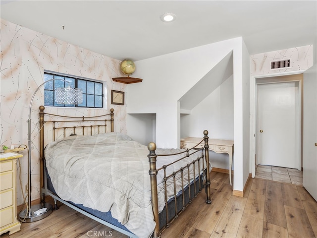 bedroom with hardwood / wood-style floors