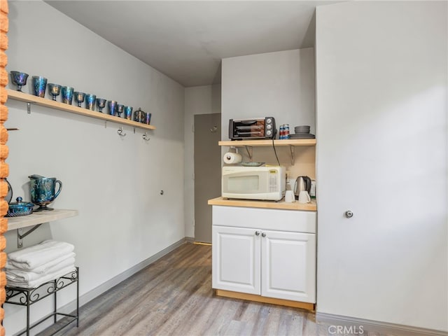 interior space featuring white cabinetry and light hardwood / wood-style floors