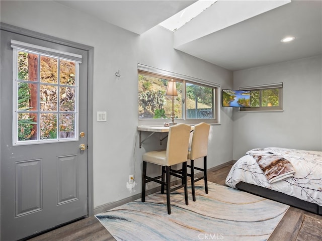 bedroom featuring multiple windows and hardwood / wood-style floors