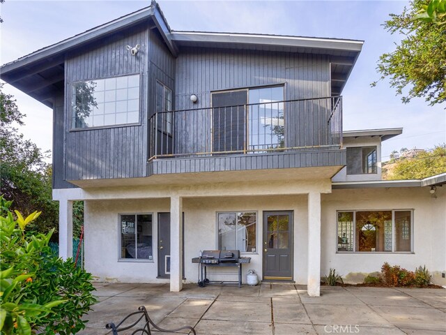 back of house with a patio area and a balcony