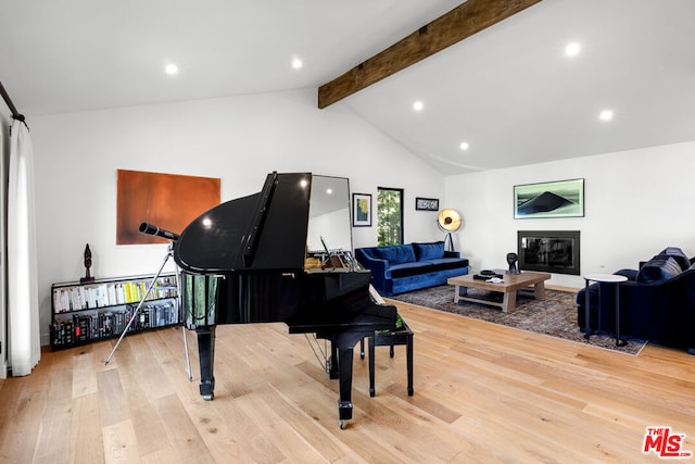 miscellaneous room featuring light hardwood / wood-style flooring and lofted ceiling with beams