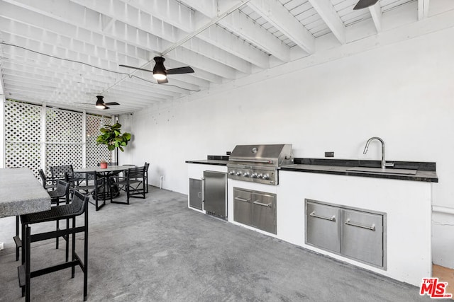 view of patio featuring ceiling fan, area for grilling, and sink