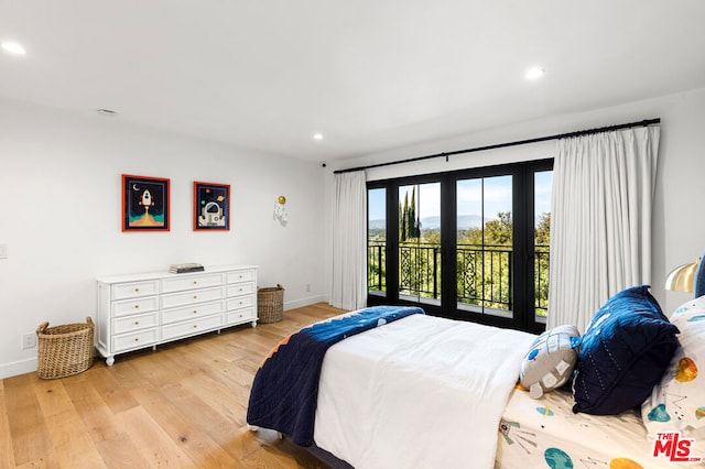 bedroom with light hardwood / wood-style flooring and access to outside