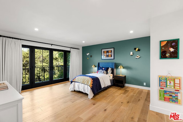 bedroom featuring french doors, access to exterior, and light hardwood / wood-style flooring