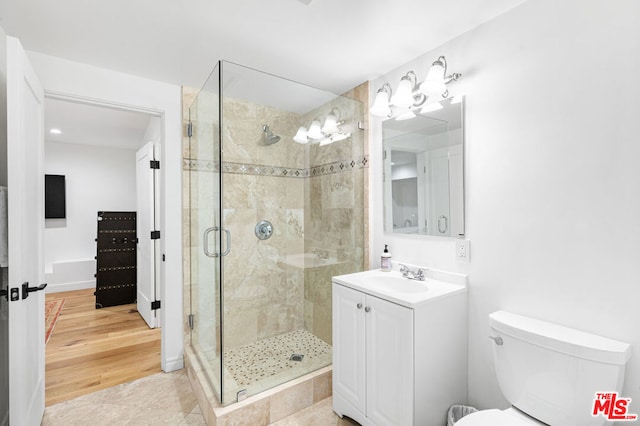 bathroom featuring vanity, toilet, tile patterned flooring, and walk in shower