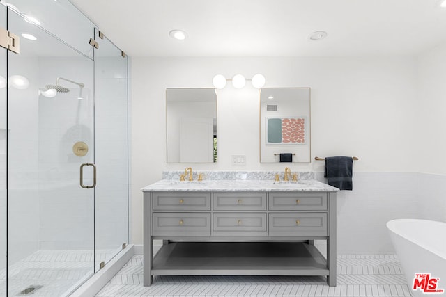 bathroom featuring vanity, shower with separate bathtub, tile patterned floors, and tile walls