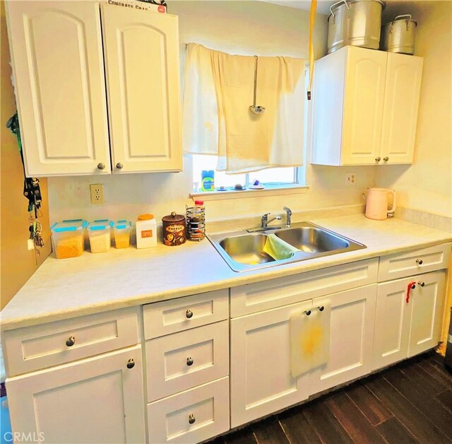 kitchen featuring white cabinets, dark hardwood / wood-style flooring, and sink