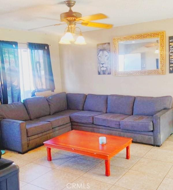 living room featuring ceiling fan and light tile patterned floors