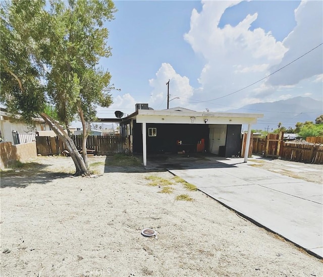 back of property with a mountain view