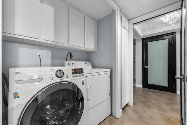 laundry area featuring washer and dryer and cabinets