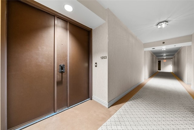 hallway with light colored carpet