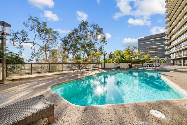 view of swimming pool with a patio