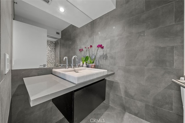 bathroom featuring tile walls and vanity