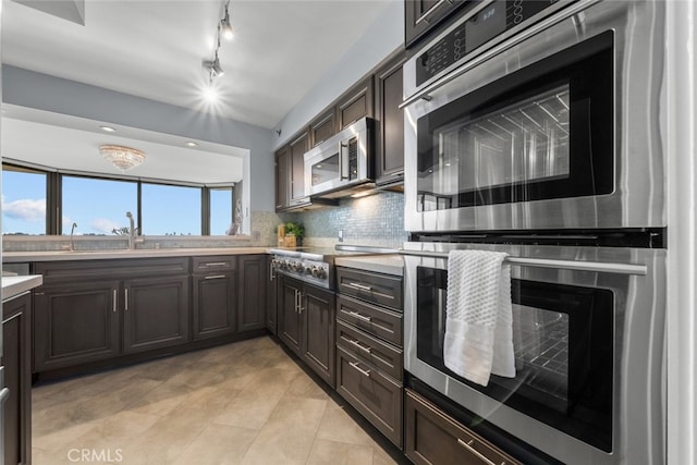 kitchen featuring decorative backsplash, sink, stainless steel appliances, and dark brown cabinets