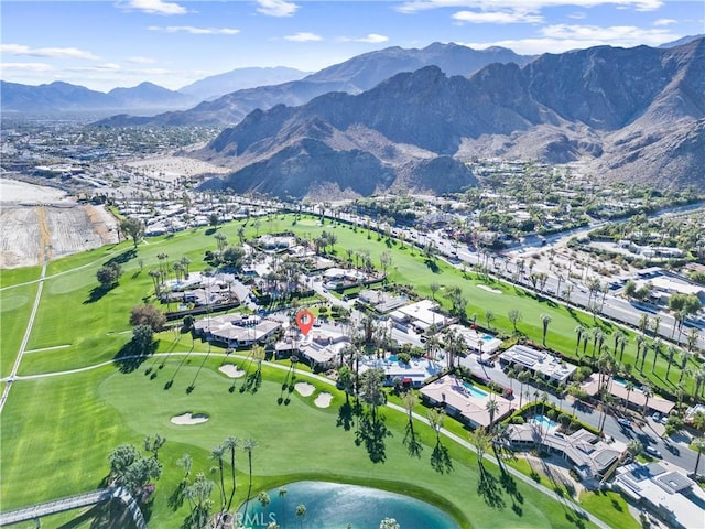 aerial view featuring view of golf course and a mountain view