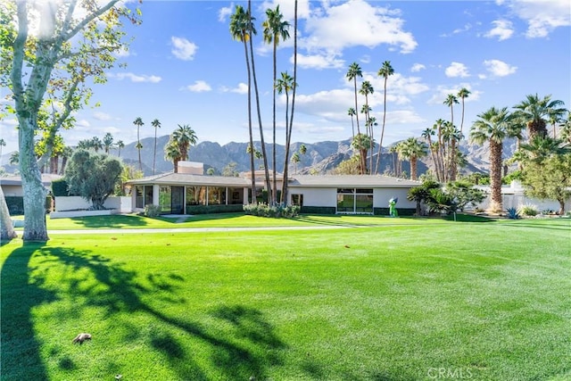 view of yard featuring a mountain view and a sunroom