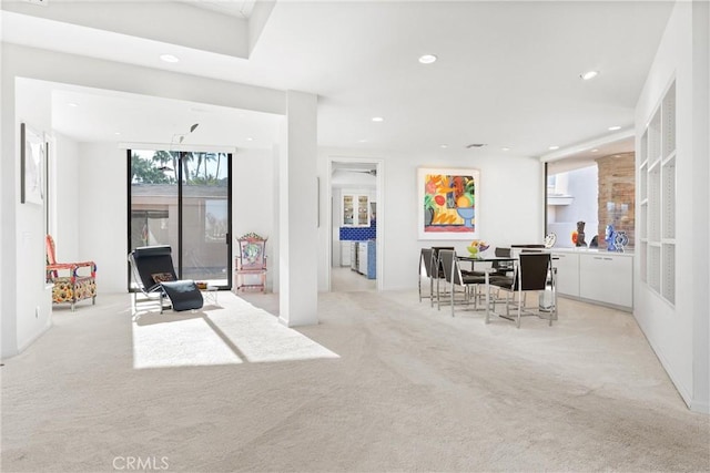 dining room featuring recessed lighting and light carpet