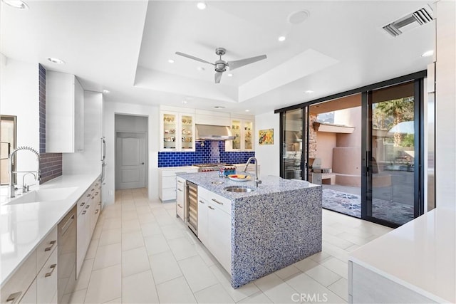 70854 Fairway Dr, Rancho Mirage, CA 92270 - kitchen with stainless steel dishwasher, tasteful backsplash, a sink, and exhaust hood