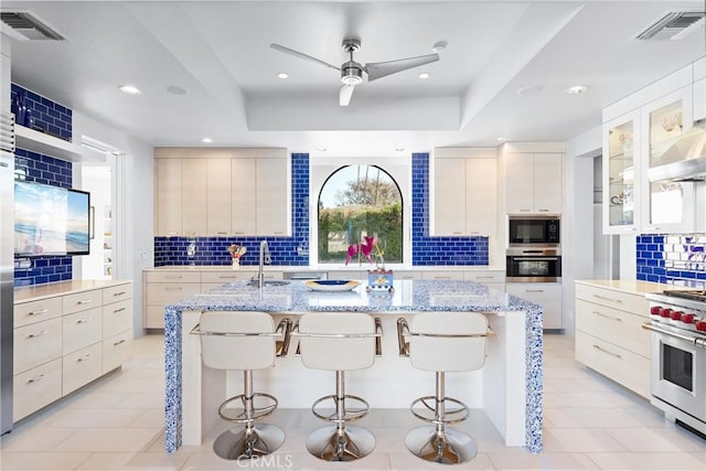 70854 Fairway Dr, Rancho Mirage, CA 92270 - kitchen with a ceiling fan, modern cabinets, stainless steel appliances, backsplash, and visible vents