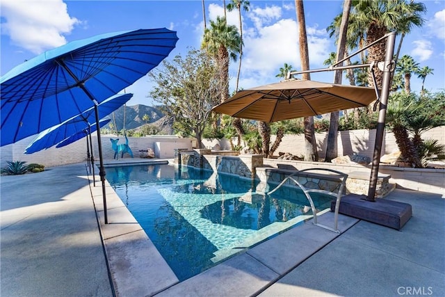 view of pool with a fenced in pool, a fenced backyard, a mountain view, and a patio area