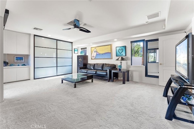 carpeted living room with visible vents, recessed lighting, and ceiling fan