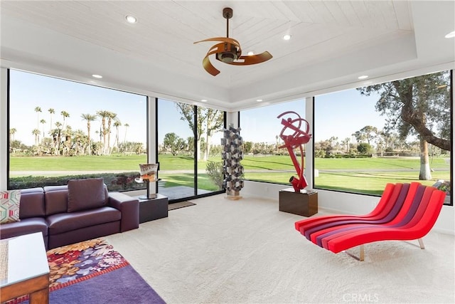 sunroom featuring a tray ceiling, wood ceiling, and ceiling fan