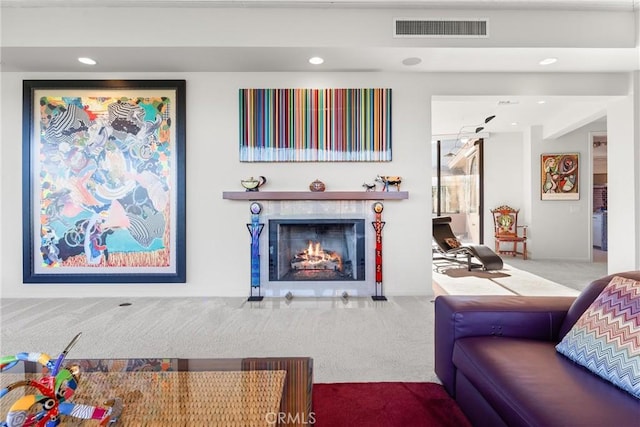 carpeted living area with a tiled fireplace, recessed lighting, and visible vents