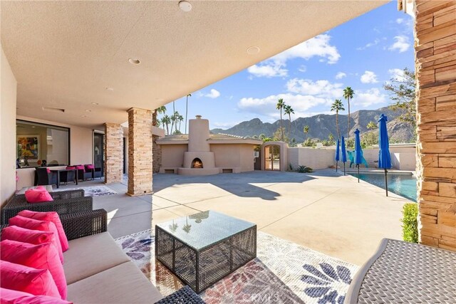70854 Fairway Dr, Rancho Mirage, CA 92270 - view of patio with a mountain view and an outdoor living space with a fireplace